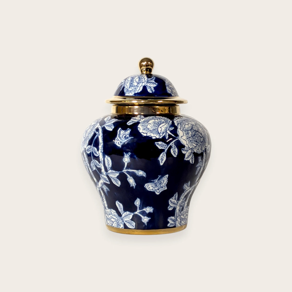 Deep navy blue porcelain ginger jar with white floral design and gold accents