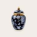 Navy blue porcelain ginger jar with white floral pattern and gold lid