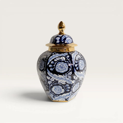 Blue and white ceramic ginger jar with polished gold-trimmed lid and floral hand-painted design
