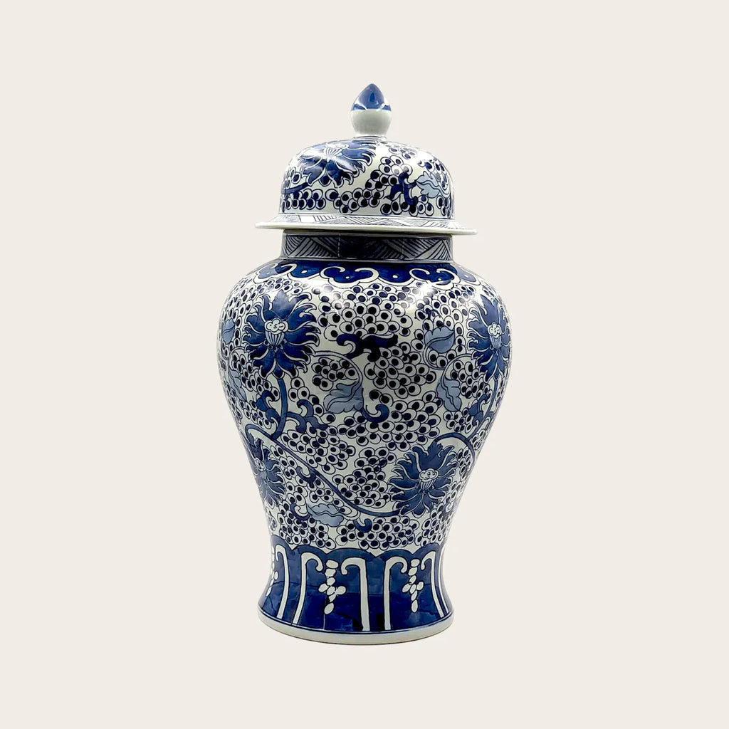 Antique fine ceramic lidded ginger jar with blue and white floral design and high-gloss glaze