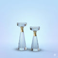 Set of two azure matte crystal and gold taper holders on light blue background