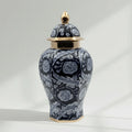 Navy floral ceramic ginger jar with gold accents on white background