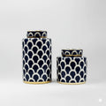 Two navy blue ceramic ginger jars with white scallop pattern and gold trim, one large and one small