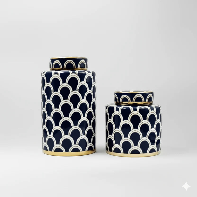 Two navy blue ceramic ginger jars with white scallop pattern and gold trim, one large and one small