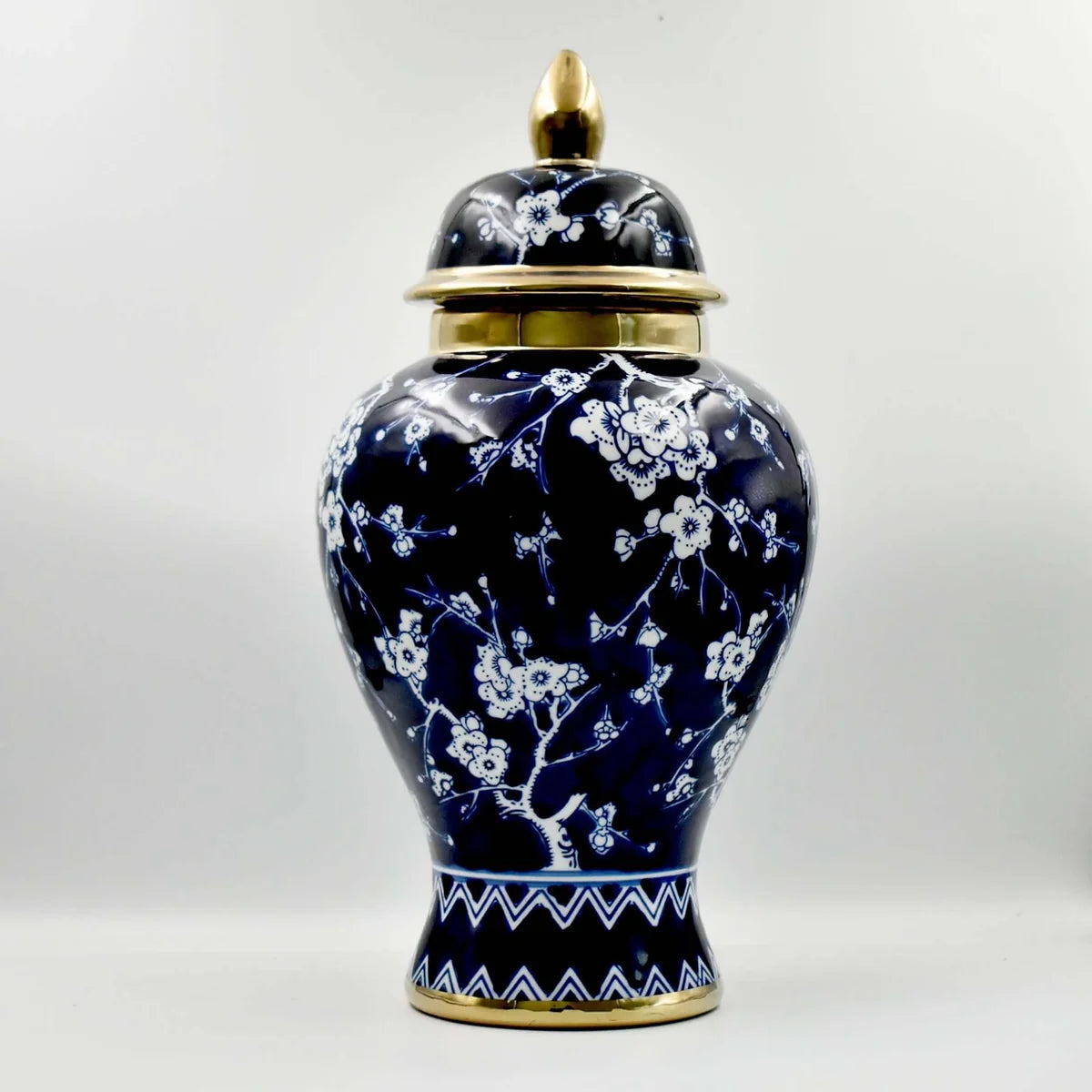 Navy blossom ceramic temple jar with gold accents and lid closed