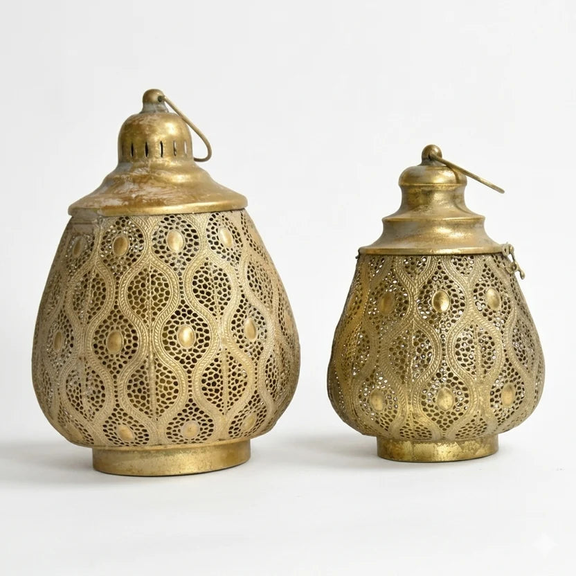 Set of two antique gold perforated iron lanterns, one large and one small, with decorative handles