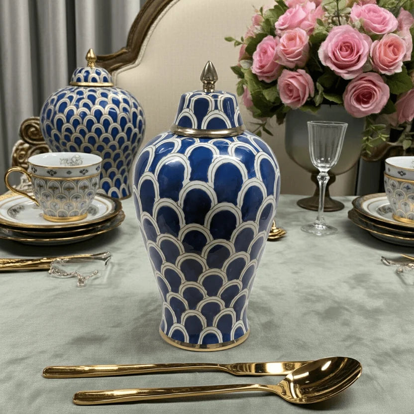 Navy blue ceramic ginger jar on elegant dining table setting with gold cutlery