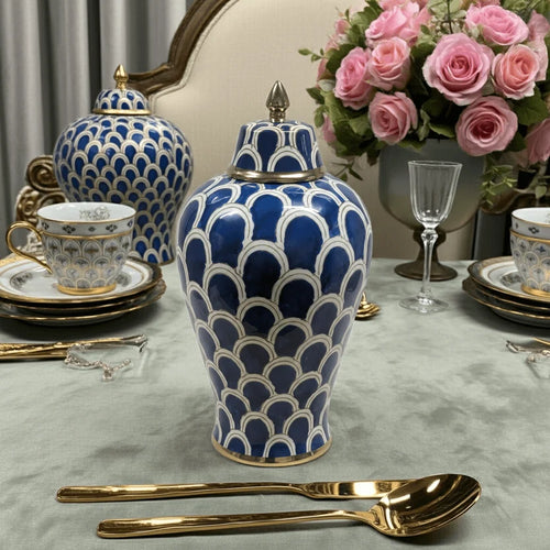 Navy blue ceramic ginger jar on elegant dining table setting with gold cutlery
