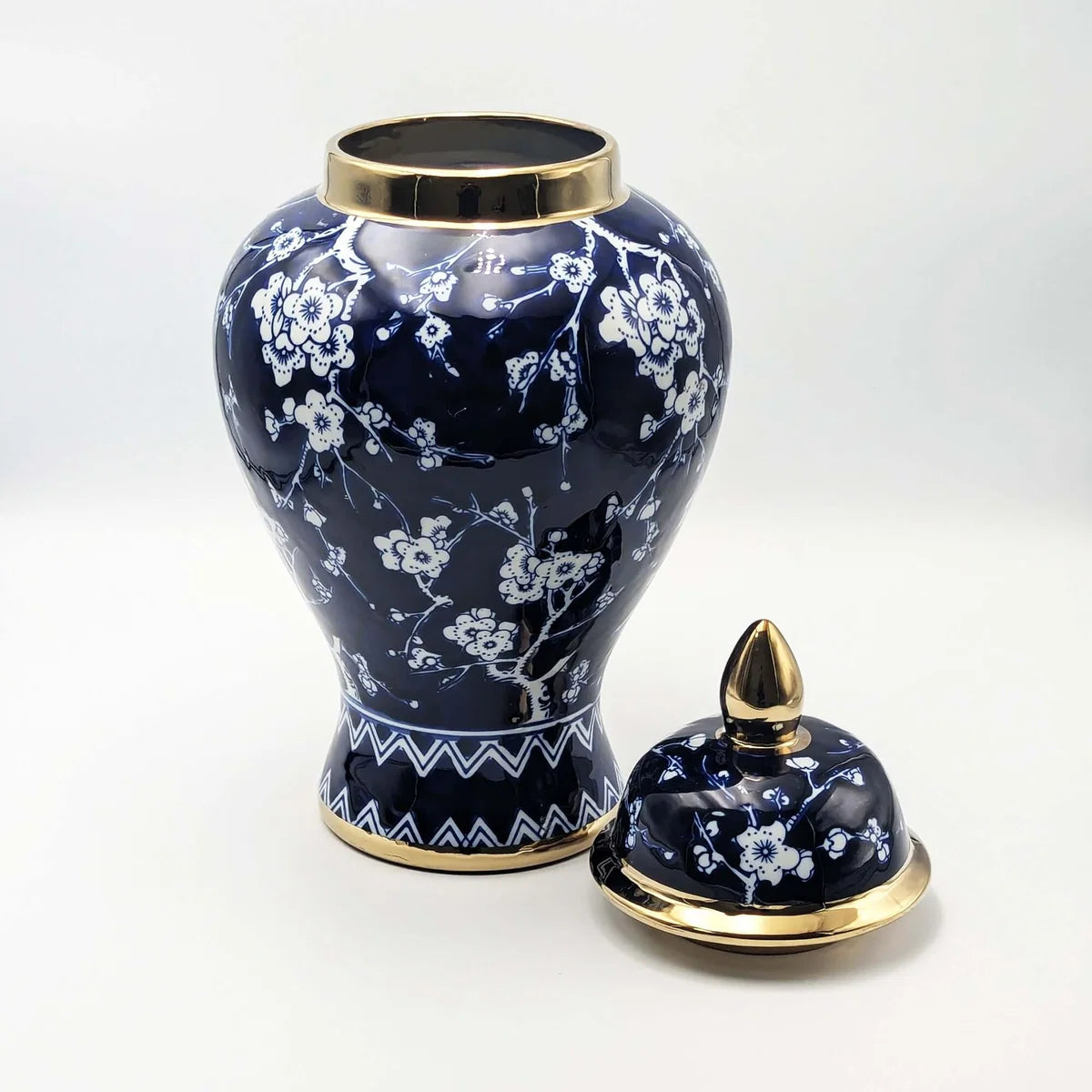 Ceramic temple jar with hand-painted blossoms and gold rim, lid removed