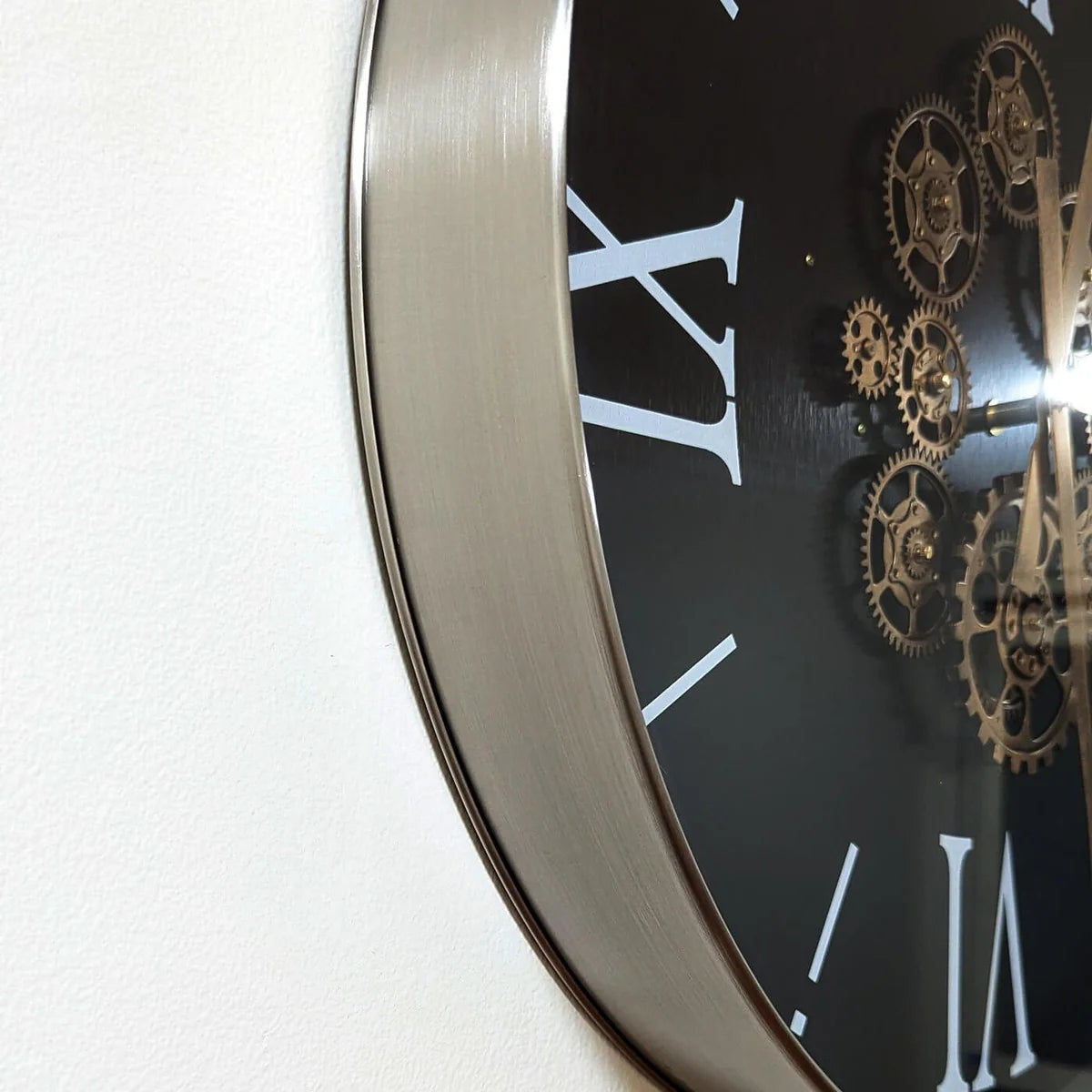 Close-up side view of the clock's metal frame and glass face