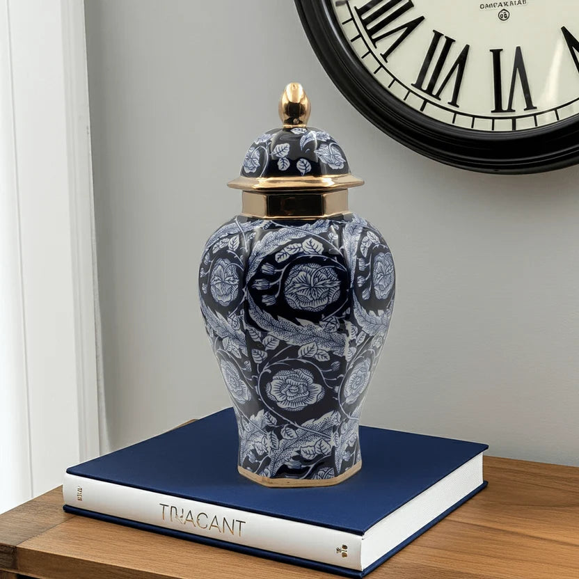 Ginger jar on top of a blue book in front of a wall clock