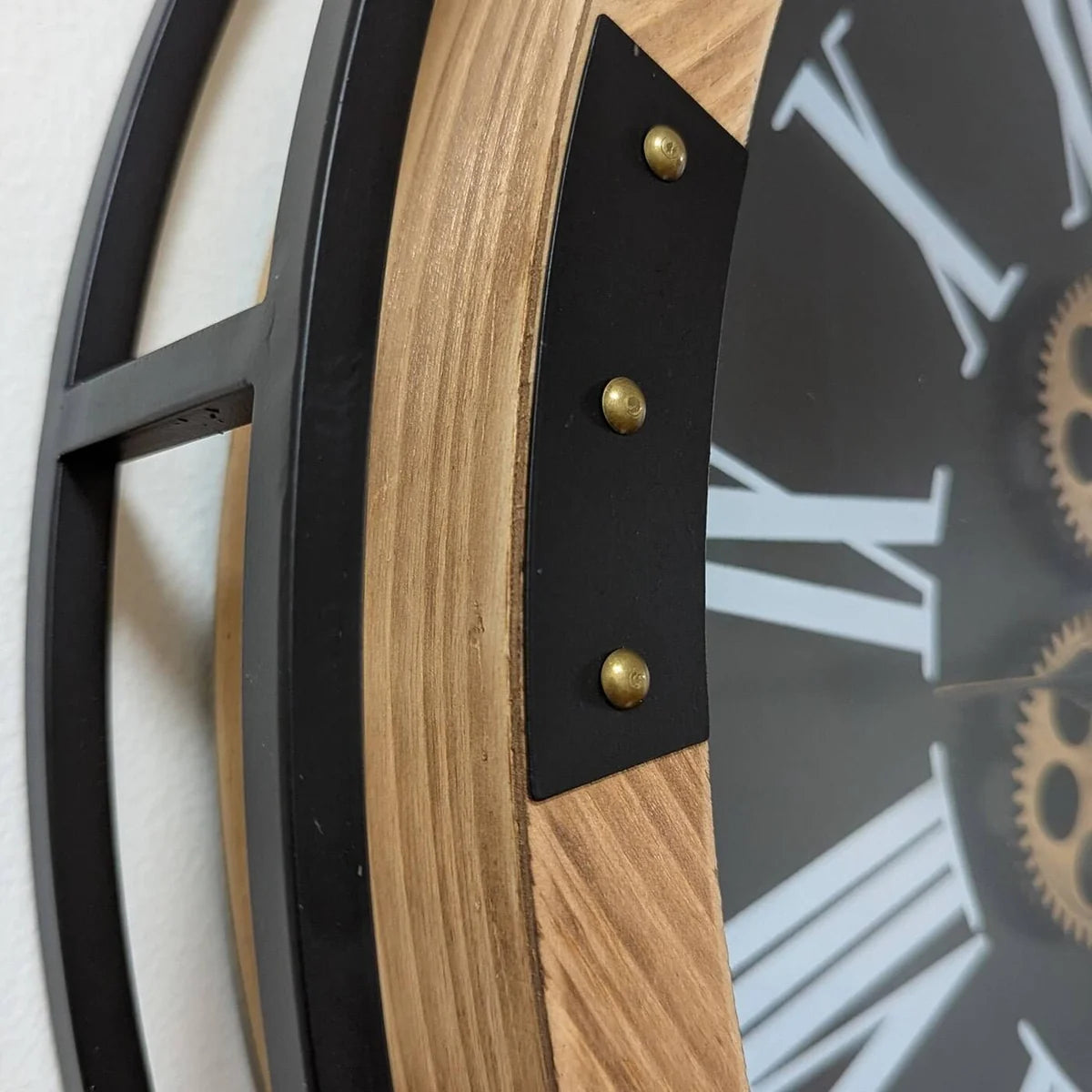 Detailed view of the metal and wood frame construction on the wall clock