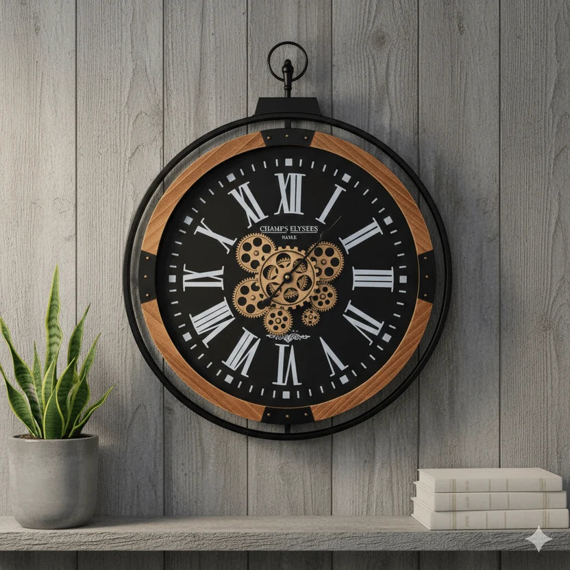 Industrial gear wall clock displayed on a grey wooden wall beside plant and books